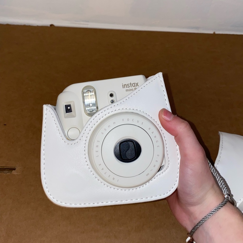 White 60mm Polaroid camera and case
